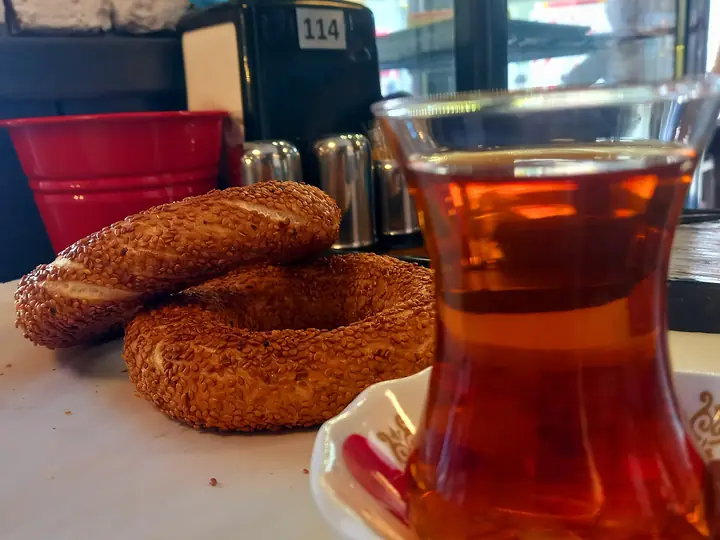 Simit mit Feta, Oliven und einem Glas türkischem Tee
