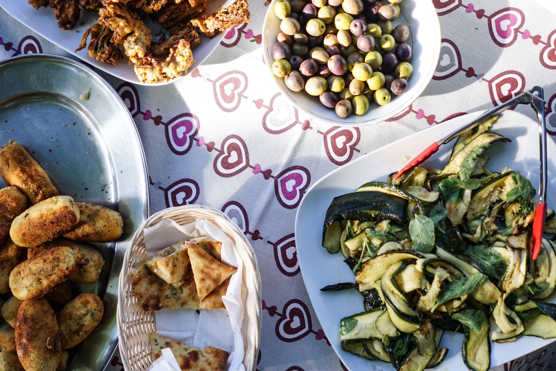 Eine reich gedeckte anatolische Tafel aus der Vogelperspektive mit verschiedenen mediterranen Speisen, Oliven und gebratenen Spezialitäten.